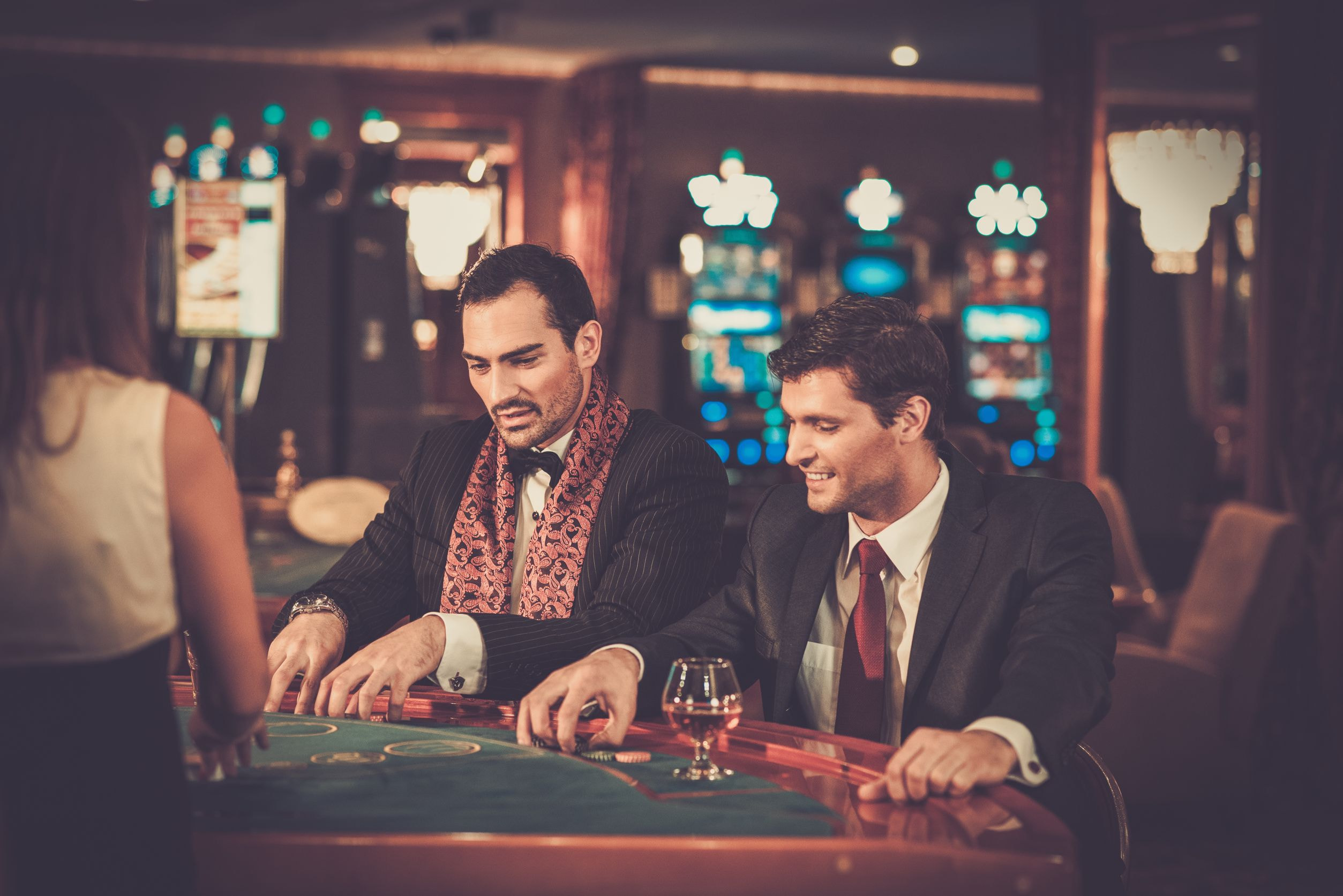 35435640 - two fashionable men in suits behind table in a casino